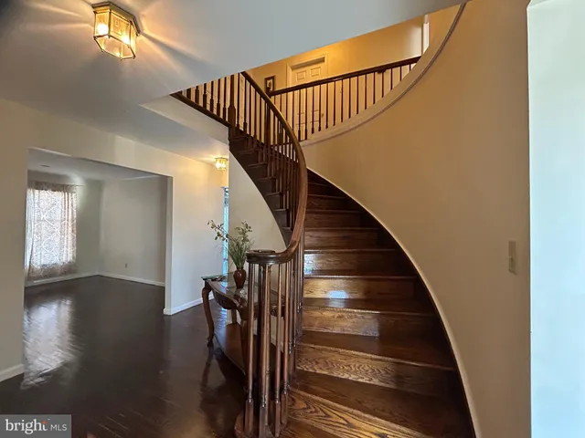 a view of entryway and hall with wooden floor