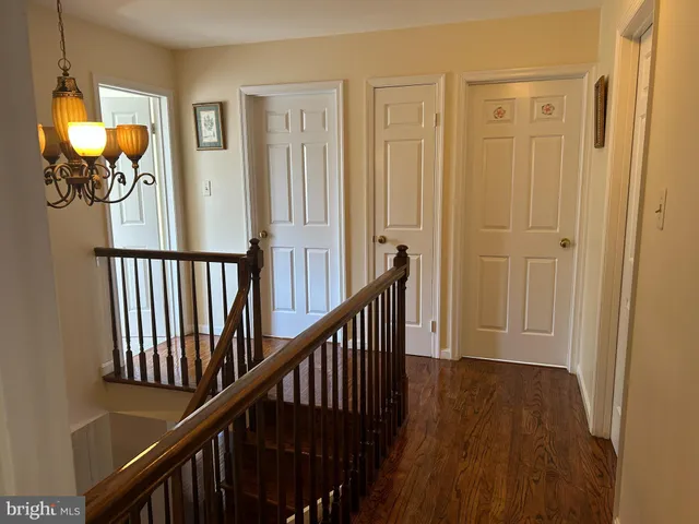 a view of a livingroom with wooden floor and stairs