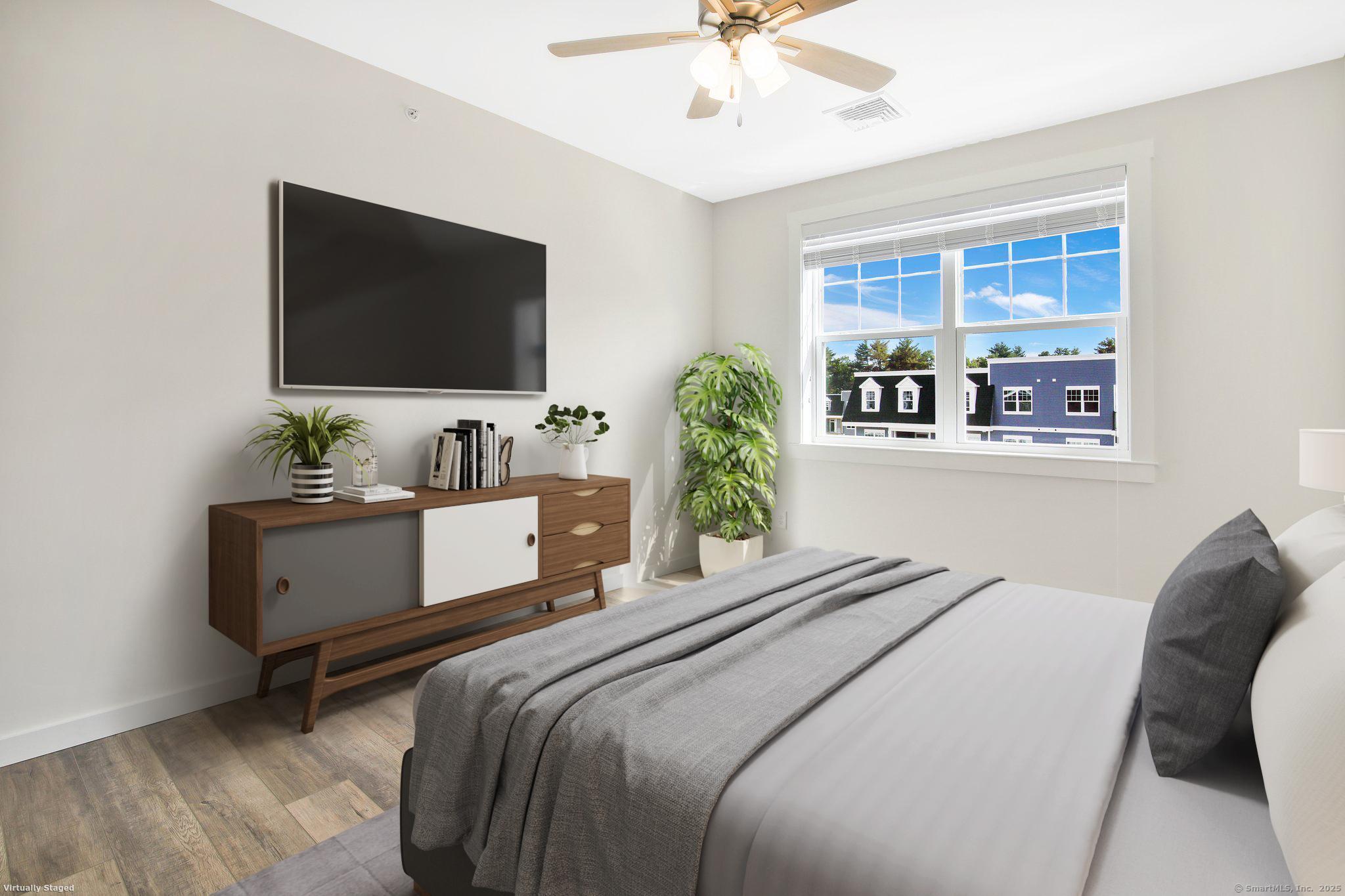 280 Salmon Brook Street, Unit 7107A Granby, CT 06035 - Photo 16 of 26 a bedroom with a bed and a flat screen tv