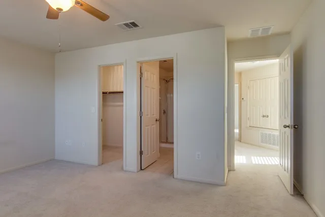 an empty room with windows and cabinet