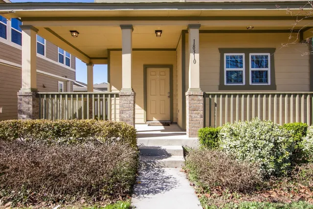 a front view of a house with a garden