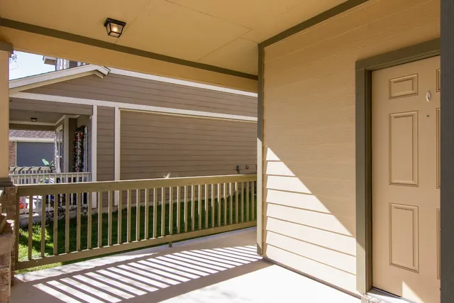 a view of a balcony with wooden floor