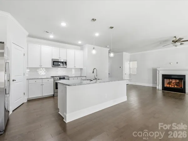 a large white kitchen with cabinets