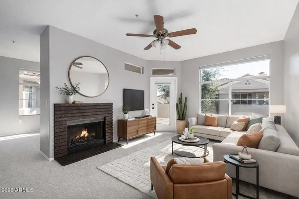 a living room with furniture a window and a fireplace