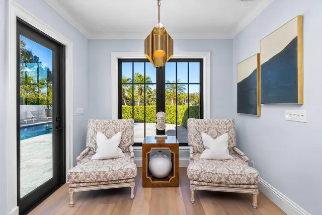 a work room with furniture and floor to ceiling windows
