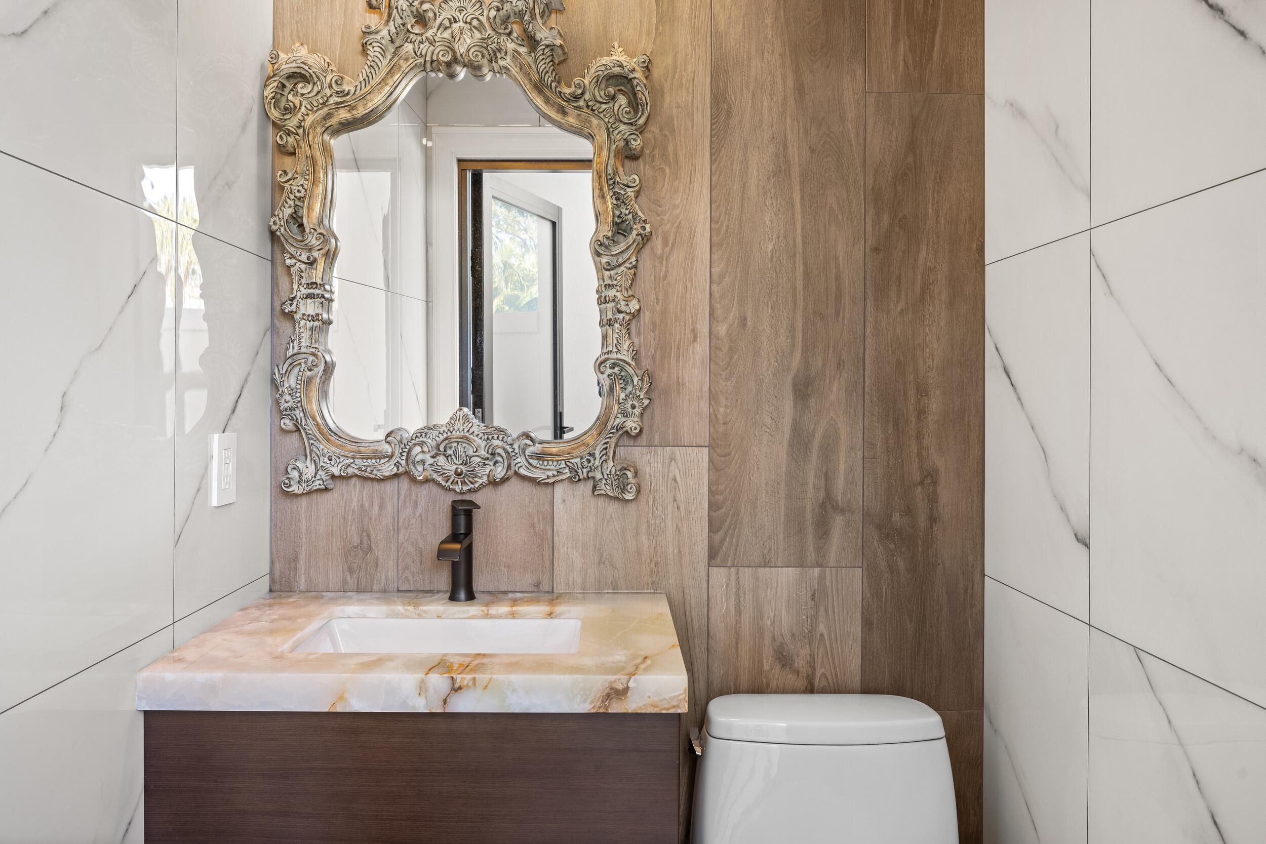 39 Country Road South Boynton Beach, FL 33436 - Photo 42 of 55 a bathroom with a granite countertop sink a toilet and a mirror