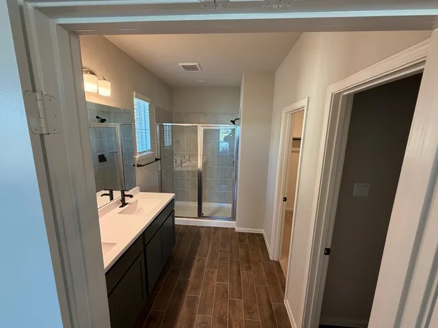 a bathroom with a sink a mirror and a shower