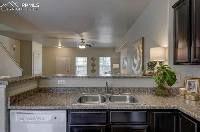 a kitchen with granite countertop a sink and cabinets