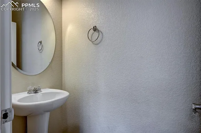 a bathroom with a sink and mirror