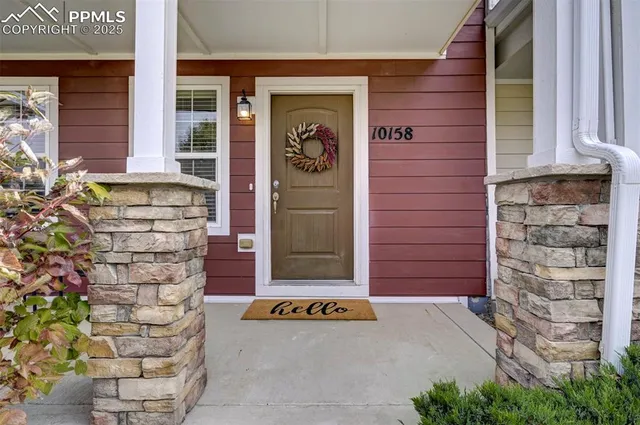 a front view of a house with a plants