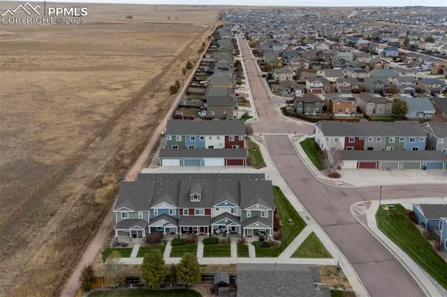 an aerial view of a residential apartment building with a yard