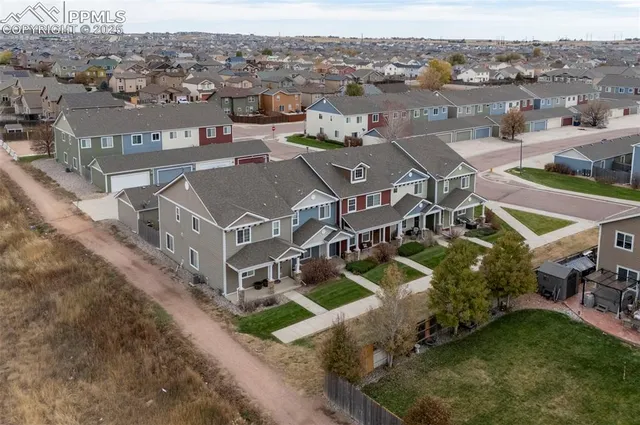 an aerial view of a house with a mountain in the background