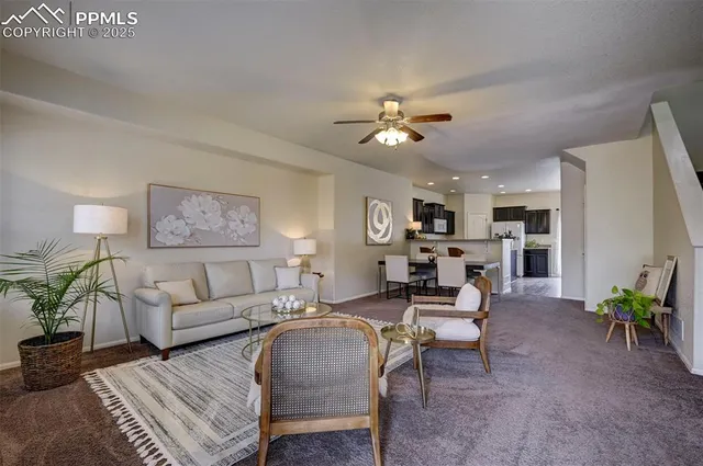 a living room with furniture potted plant and a window