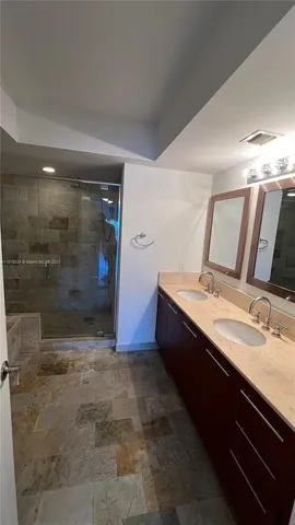 a spacious bathroom with a sink and a mirror