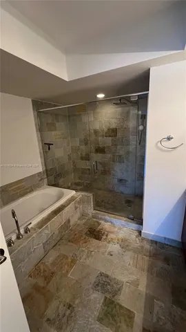 a bathroom with a shower and a sink