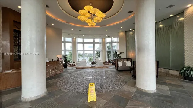 a view of a lobby with furniture and floor to ceiling window