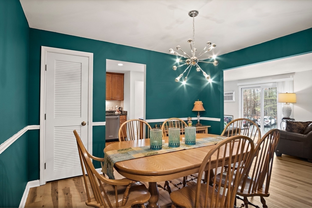 386 Great Road, Unit A8 Acton, MA 01720 - Photo 13 of 26 a view of a dining room with furniture window and wooden floor