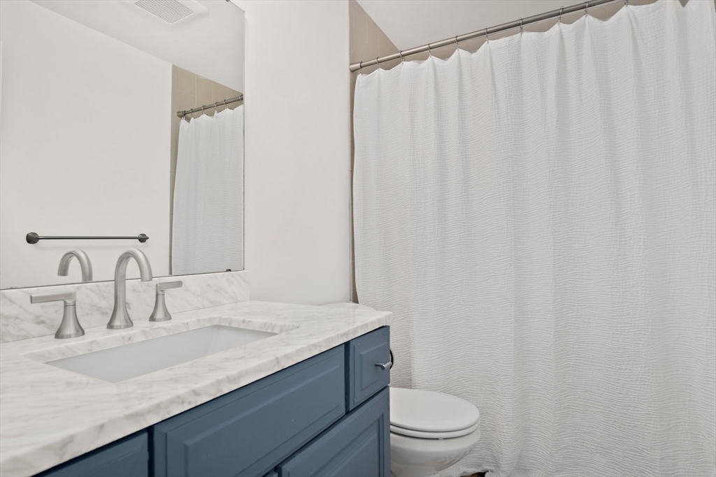 386 Great Road, Unit A8 Acton, MA 01720 - Photo 16 of 26 a bathroom with a granite countertop sink and a mirror