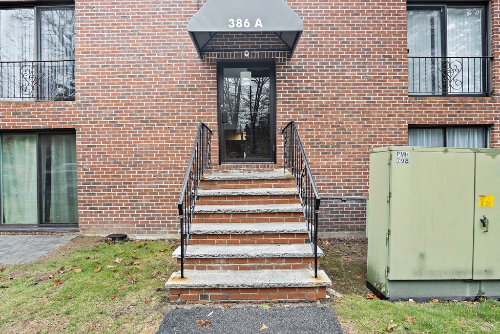 386 Great Road, Unit A8 Acton, MA 01720 - Photo 4 of 26 a front view of a house with a window