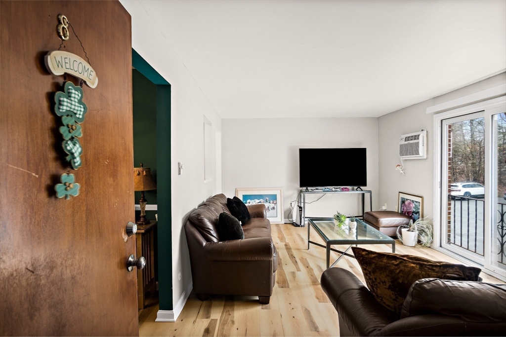386 Great Road, Unit A8 Acton, MA 01720 - Photo 6 of 26 a living room with furniture and a flat screen tv