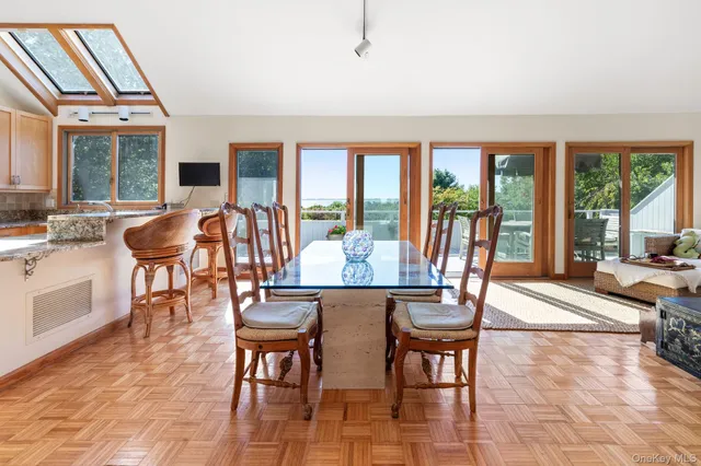 a view of a dining room with furniture large windows and wooden floor