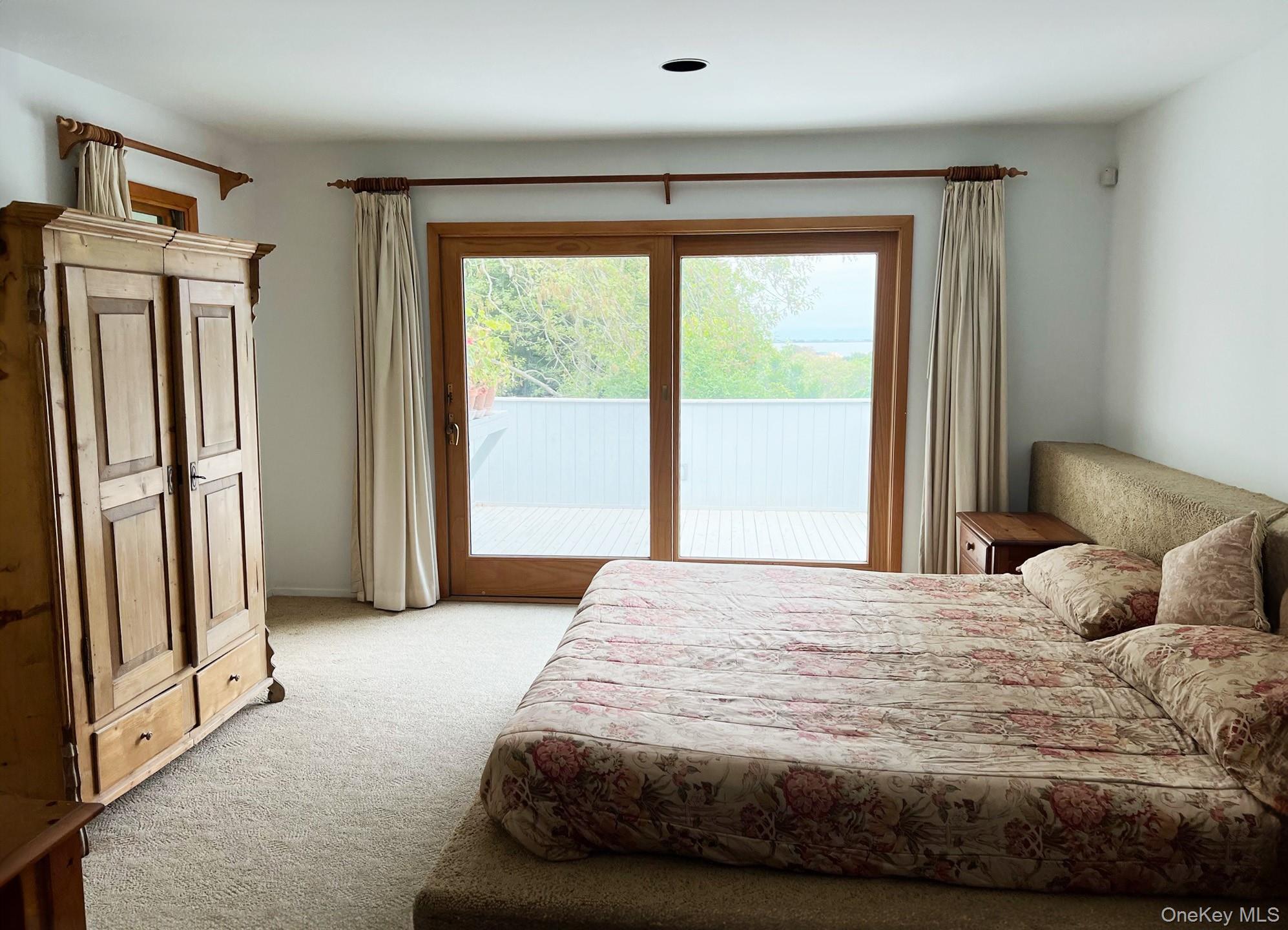 29 Kenwood Road Southampton, NY 11968 - Photo 14 of 35 a bedroom with a bed and a large window