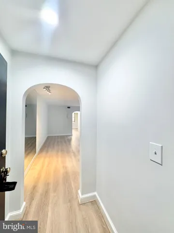a view of a hallway with wooden floor