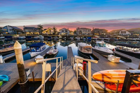 a large kitchen with stainless steel appliances a large center island attached withe living room