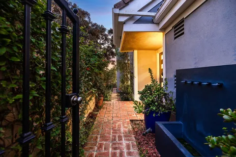 a view of a hallway with wooden floor and glass door