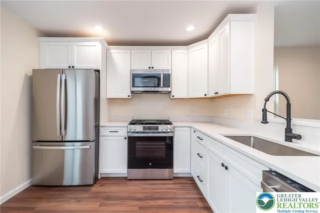 a kitchen with wooden cabinets and stainless steel appliances