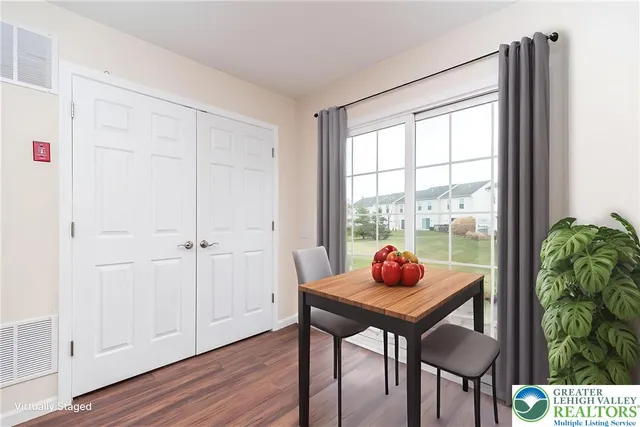 a dining room with furniture and window