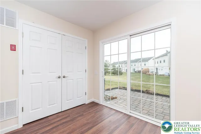 a view of a room with wooden floor and windows