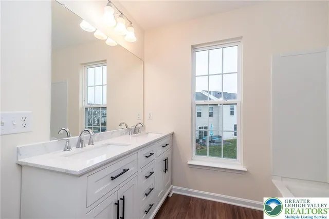 a bathroom with a sink a vanity and a large mirror