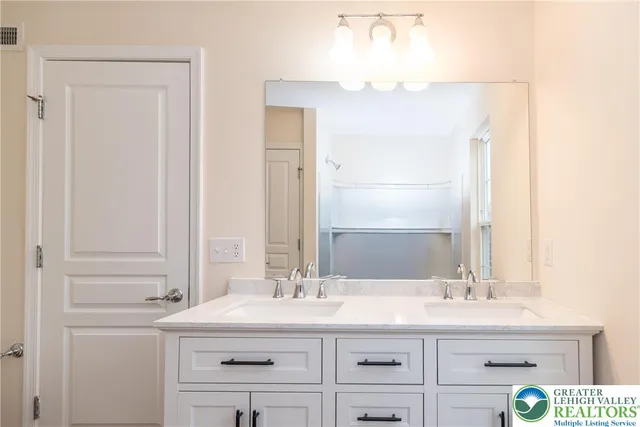 a bathroom with a sink vanity and a mirror