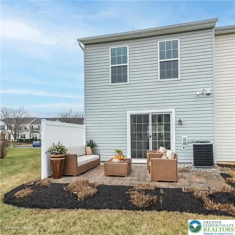a front view of a house with swimming pool and furniture