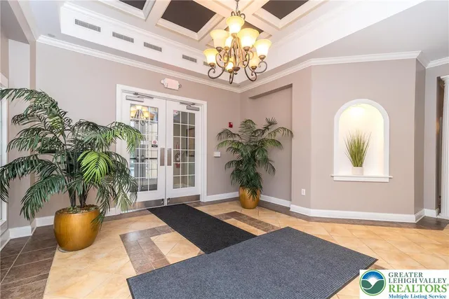 a vase of flowers sitting on a table in front of a window