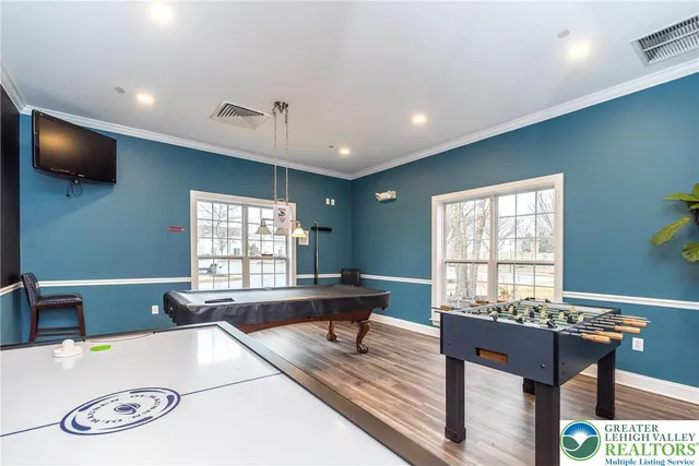 a living room with furniture a window and a flat screen tv