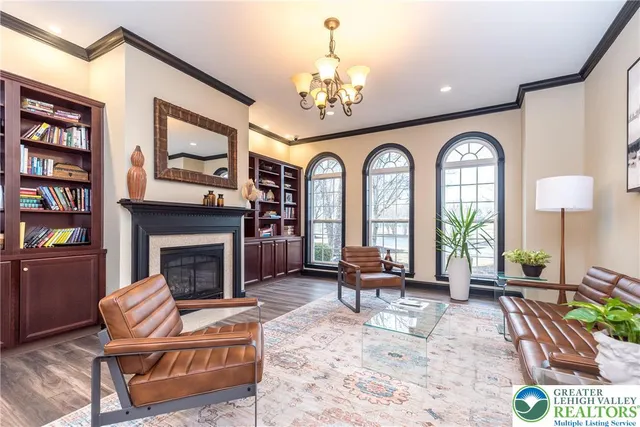 a living room with furniture a fireplace and a chandelier