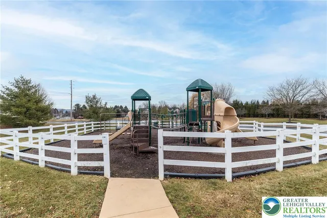 a view of a house with wooden deck and furniture