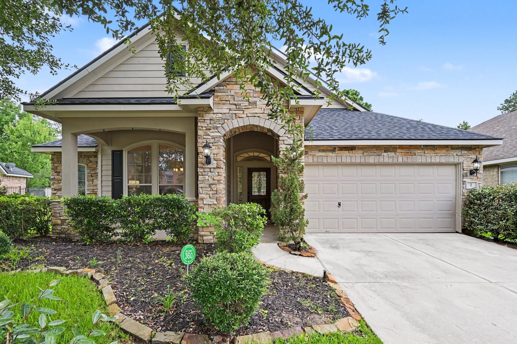 7 Fraiser Fir Place Spring, TX 77389 - Photo 1 of 26 a front view of a house with garden