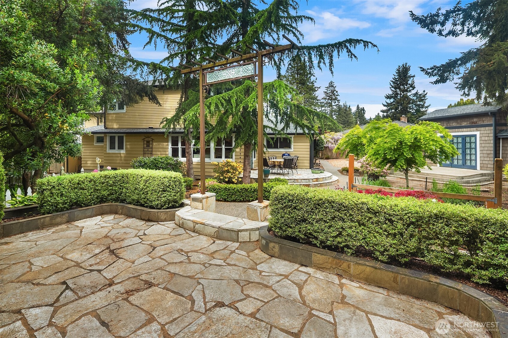 7732 195th Street Southwest Edmonds, WA 98026 - Photo 29 of 39 a front view of a house with a yard and potted plants