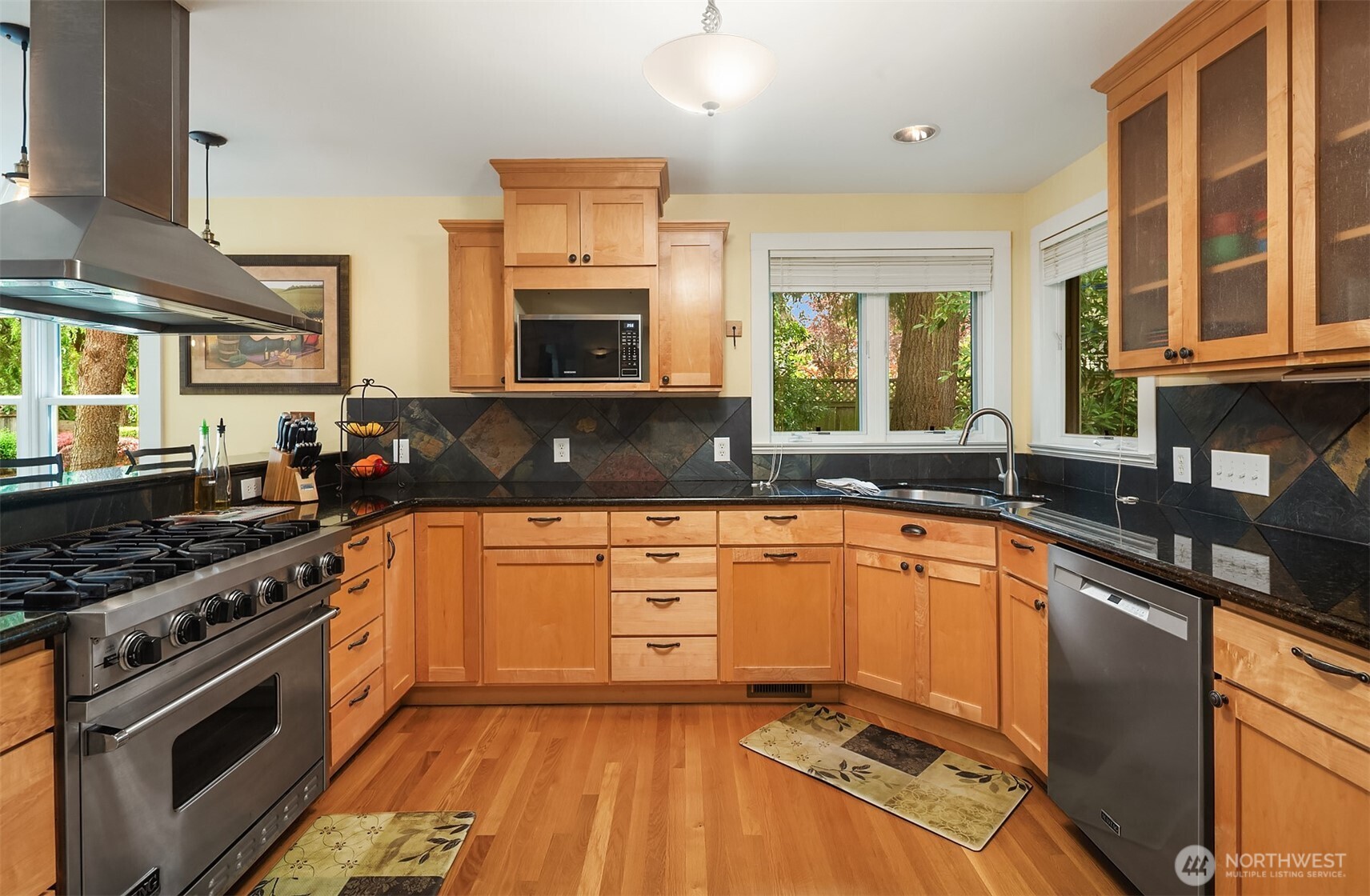 7732 195th Street Southwest Edmonds, WA 98026 - Photo 6 of 39 a kitchen with stainless steel appliances granite countertop a stove a sink and a granite counter tops