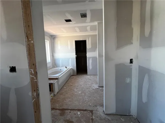 a bathroom with a tub and shower