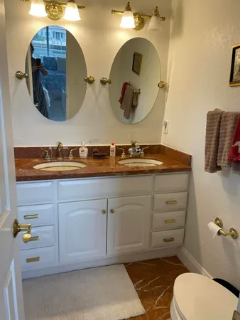 a bathroom with a toilet sink and mirror