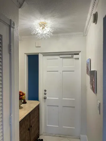 a bathroom with a light fixture a mirror and a sink