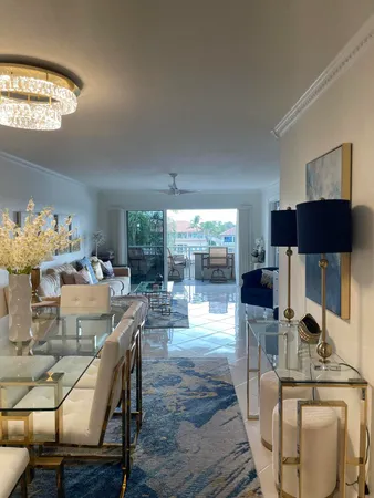 a view of a dining room with furniture a chandelier and wooden floor