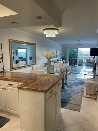 a dining hall with stainless steel appliances granite countertop a stove and a sink
