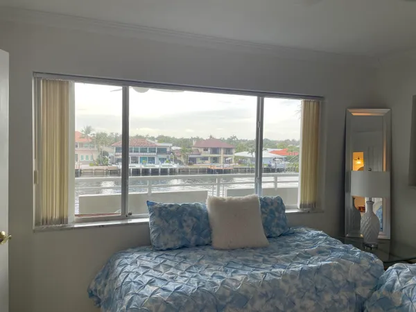 a bedroom with a large bed and a large window