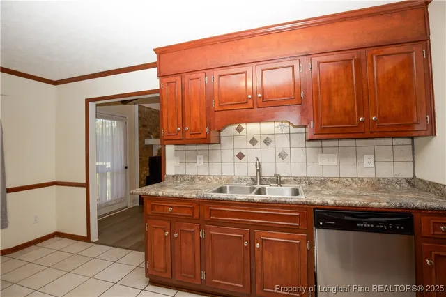 a kitchen with granite countertop cabinets and window