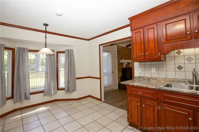 a kitchen with stainless steel appliances granite countertop a refrigerator a stove and a sink
